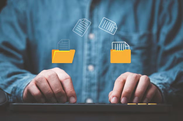 Man's hands on the keyboard, in the foreground there are folders with files