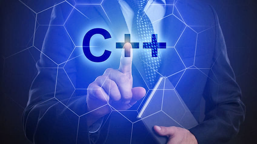 A man presses his finger on the C++ sign